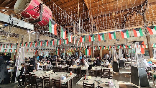 Restaurant Co. covered dining hall decorated with Kuwait flags